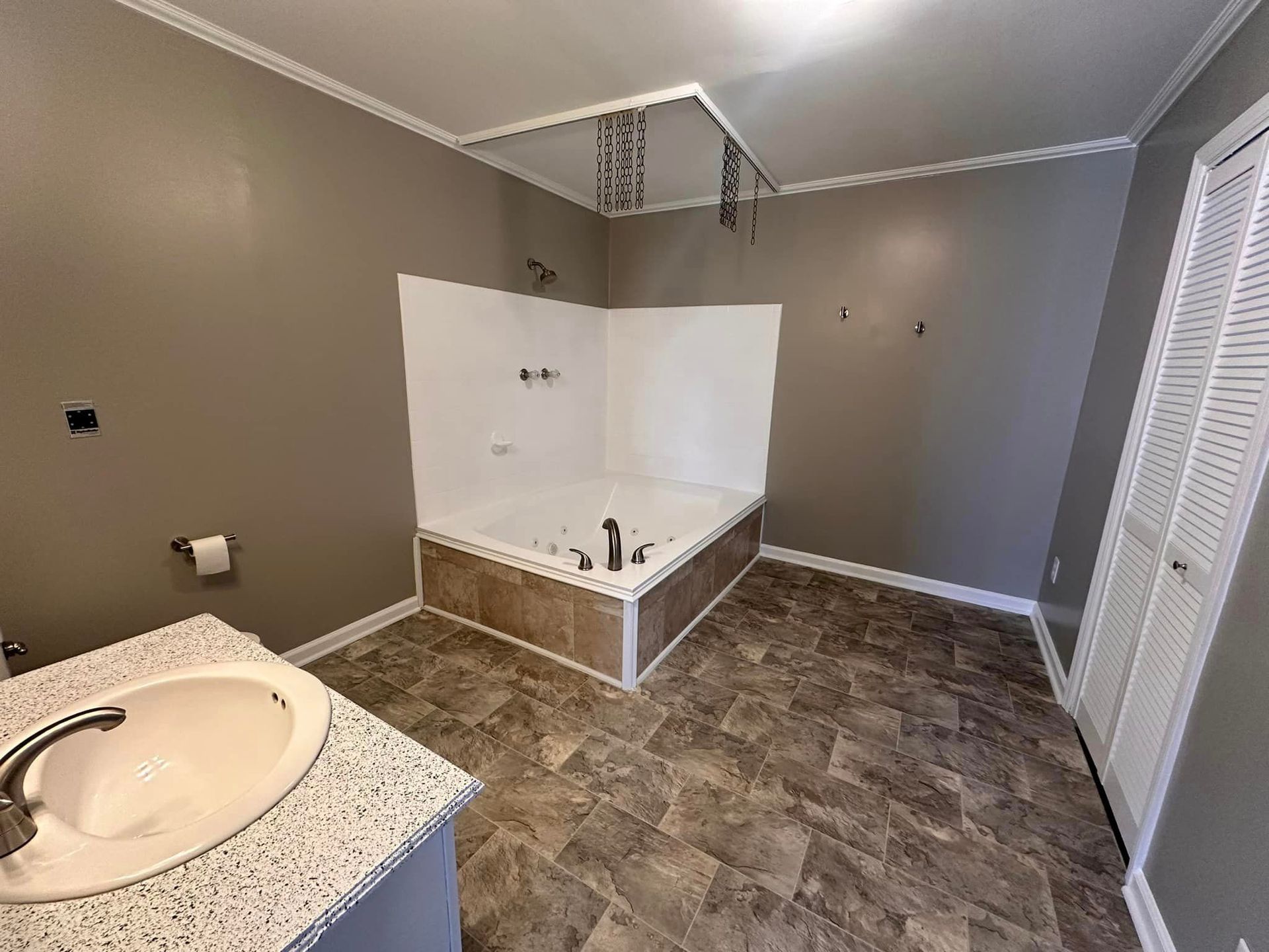 A bathroom with a sink , tub and shower.