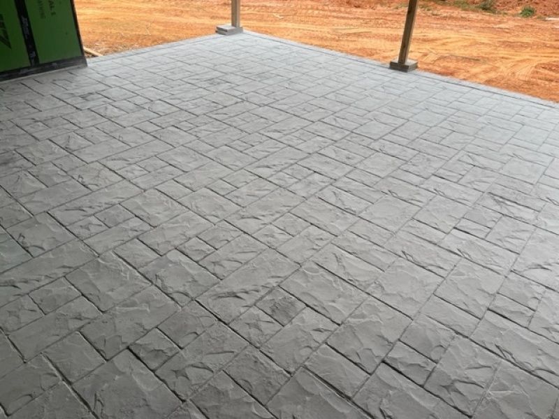 A concrete floor with a brick pattern on it