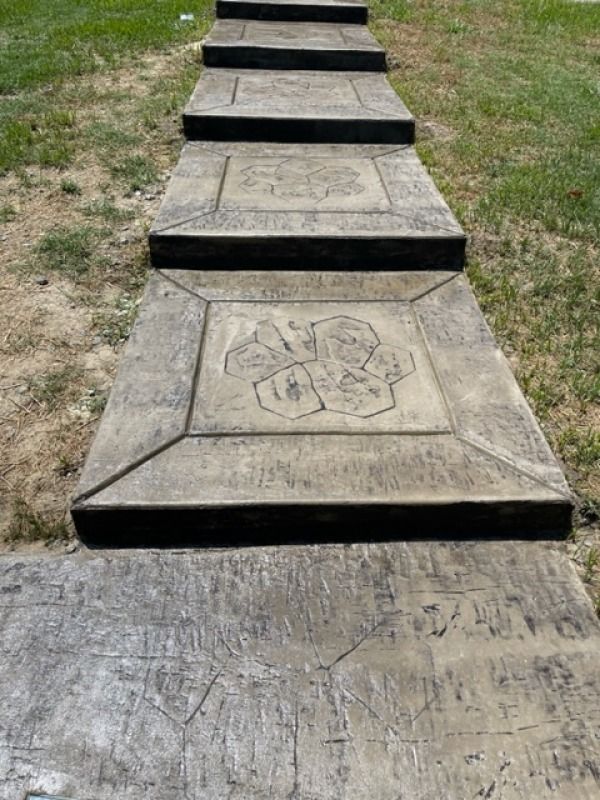 A row of concrete steps leading up to a grassy area.