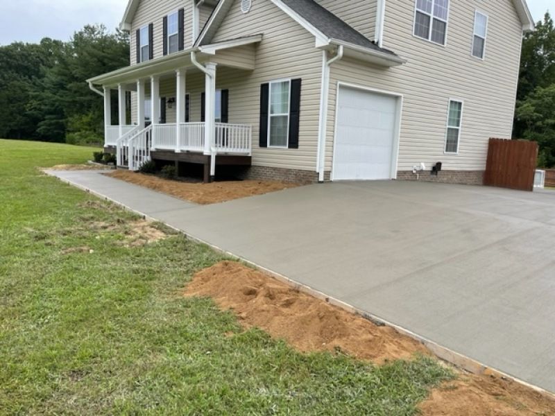A large house with a concrete driveway in front of it.