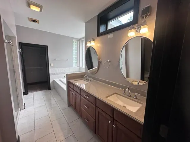 A bathroom with two sinks and two mirrors