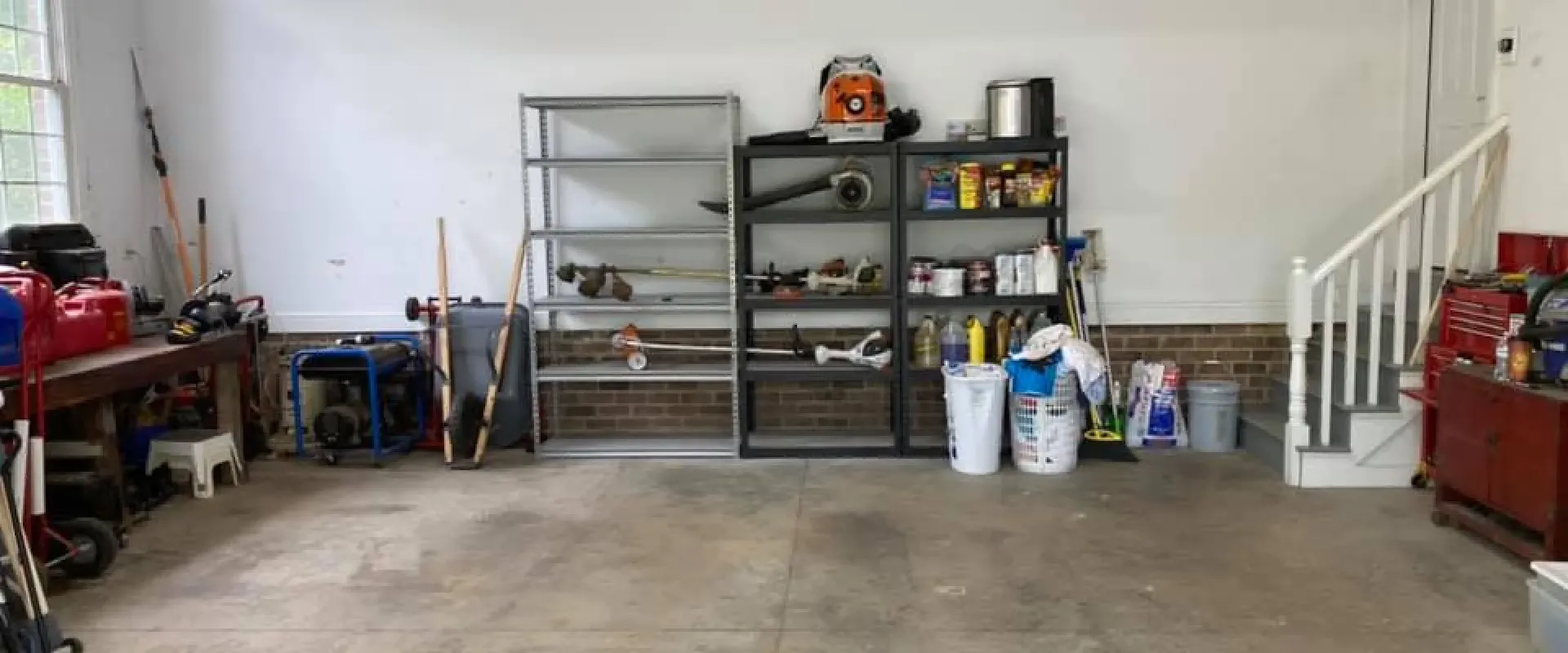 A garage filled with lots of tools and a staircase.
