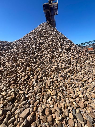 A pile of rocks sitting on top of a gravel road.