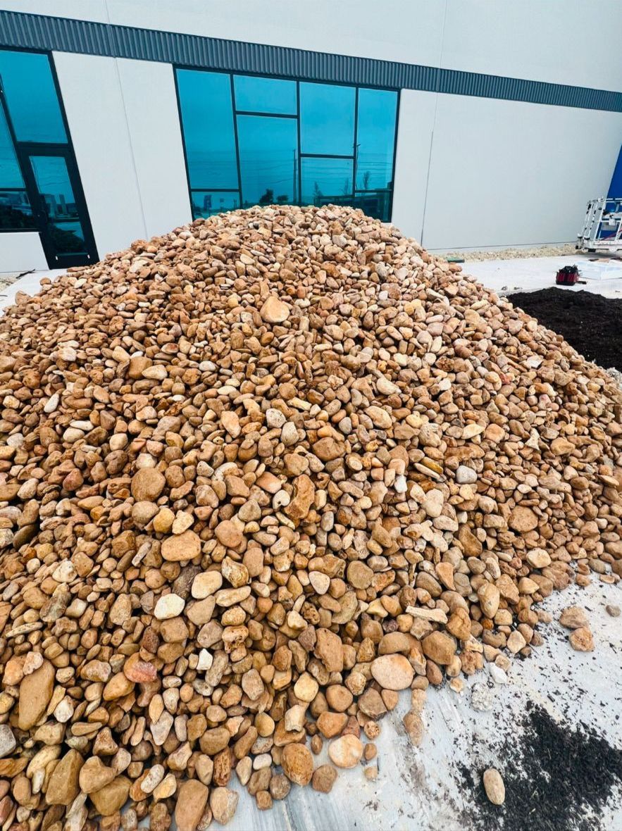 A pile of gravel is sitting in front of a building