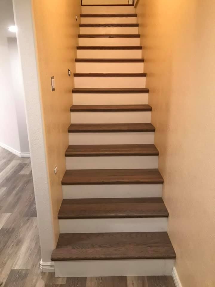 a set of wooden stairs leading up to the second floor of a house .