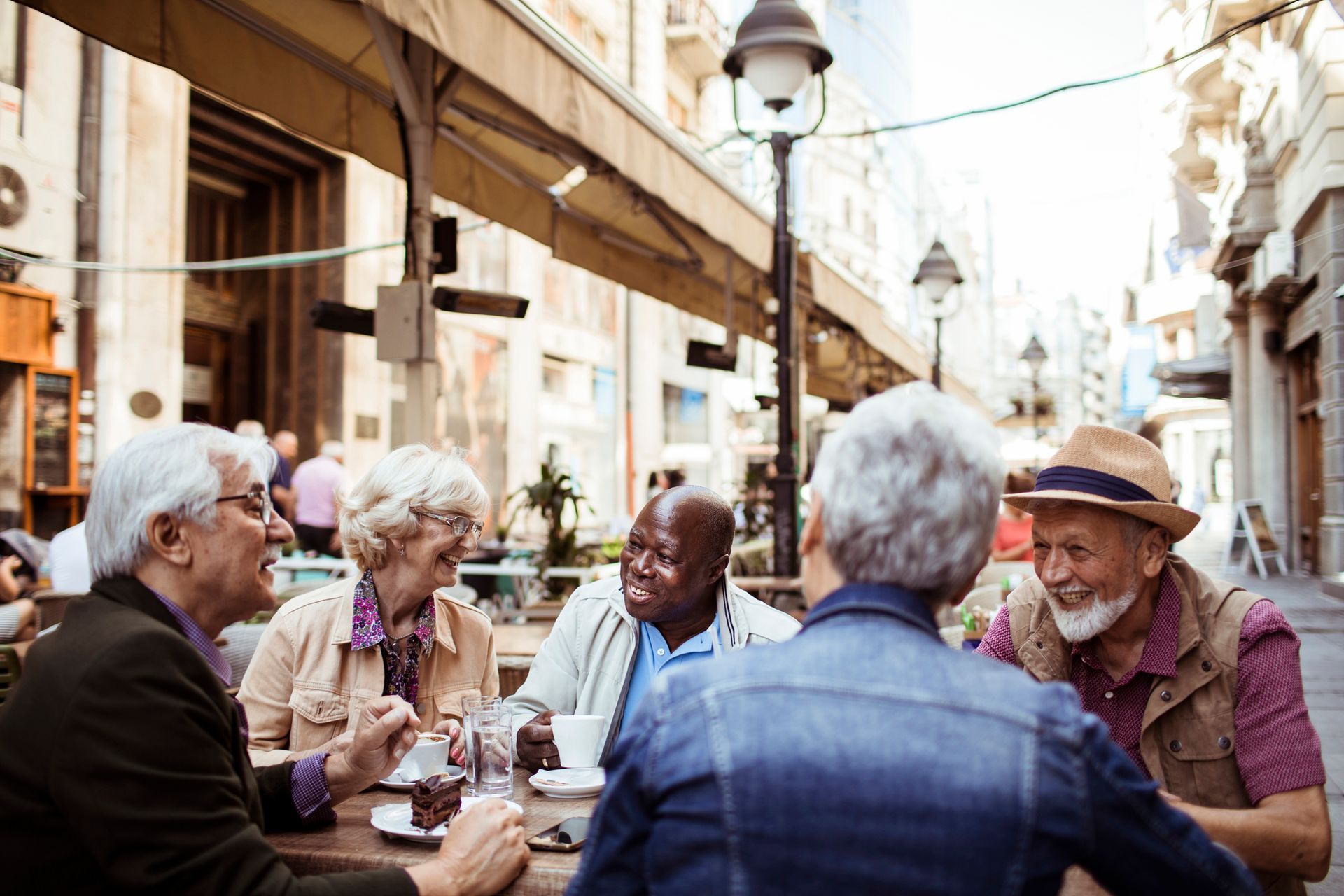 A group of older people are sitting at a table in a restaurant.