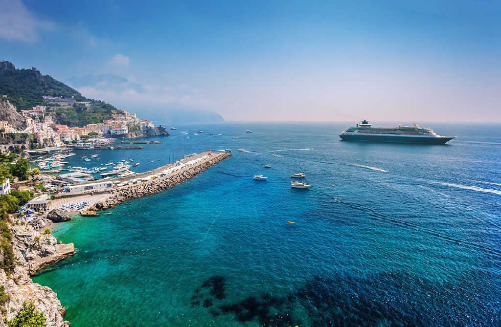 A cruise ship is floating on top of a body of water.
