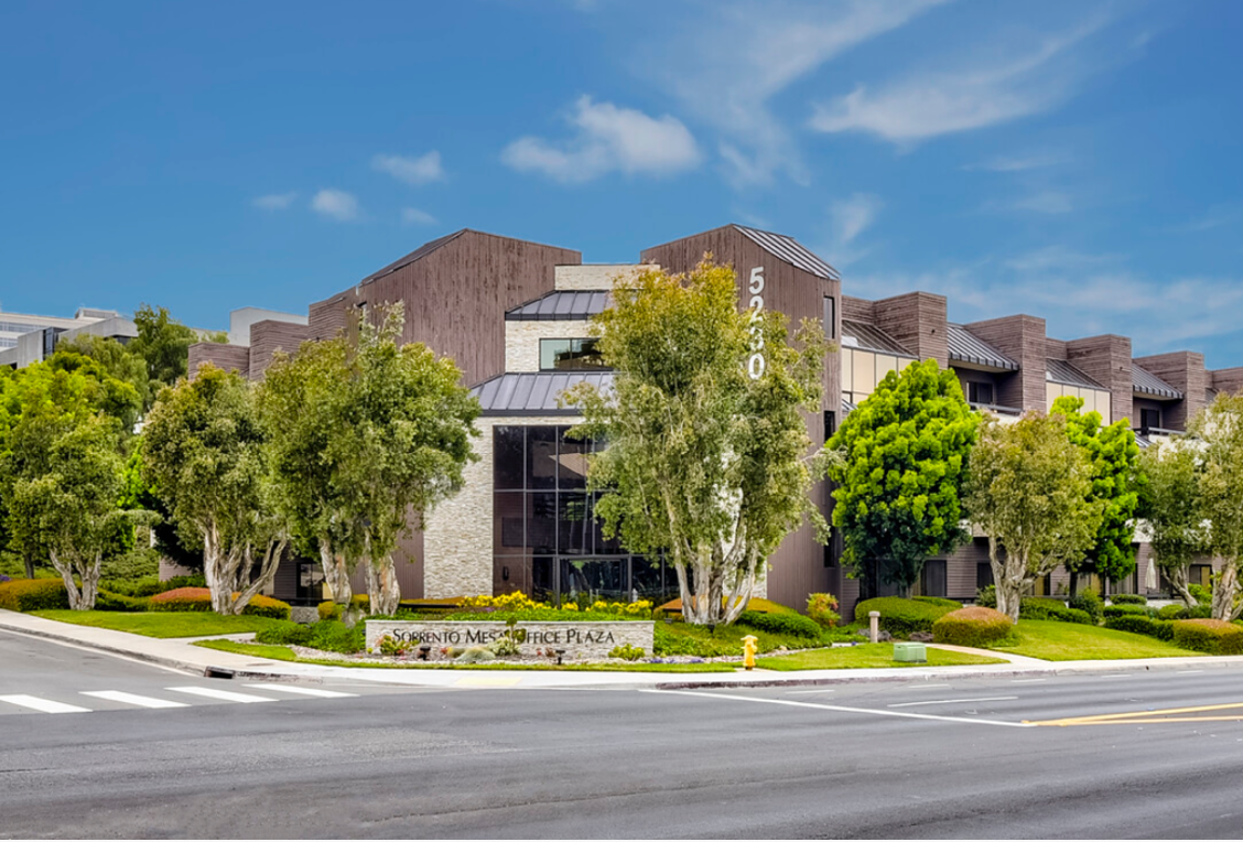 A large building with a lot of trees in front of it.