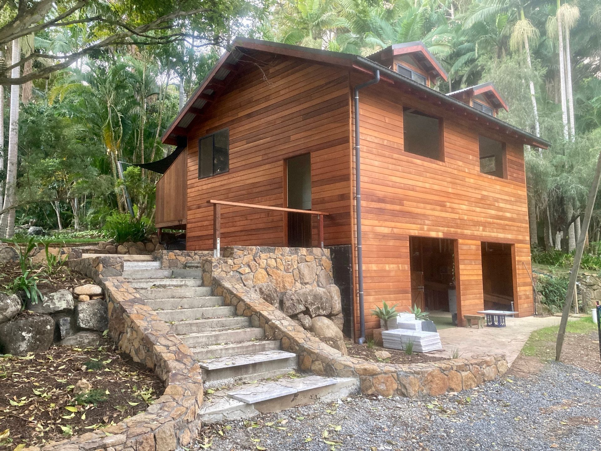 Wooden Cabin with Stone Steps on A Hillside in A Lush Forest Setting — WJG Built in Byron Bay, NSW