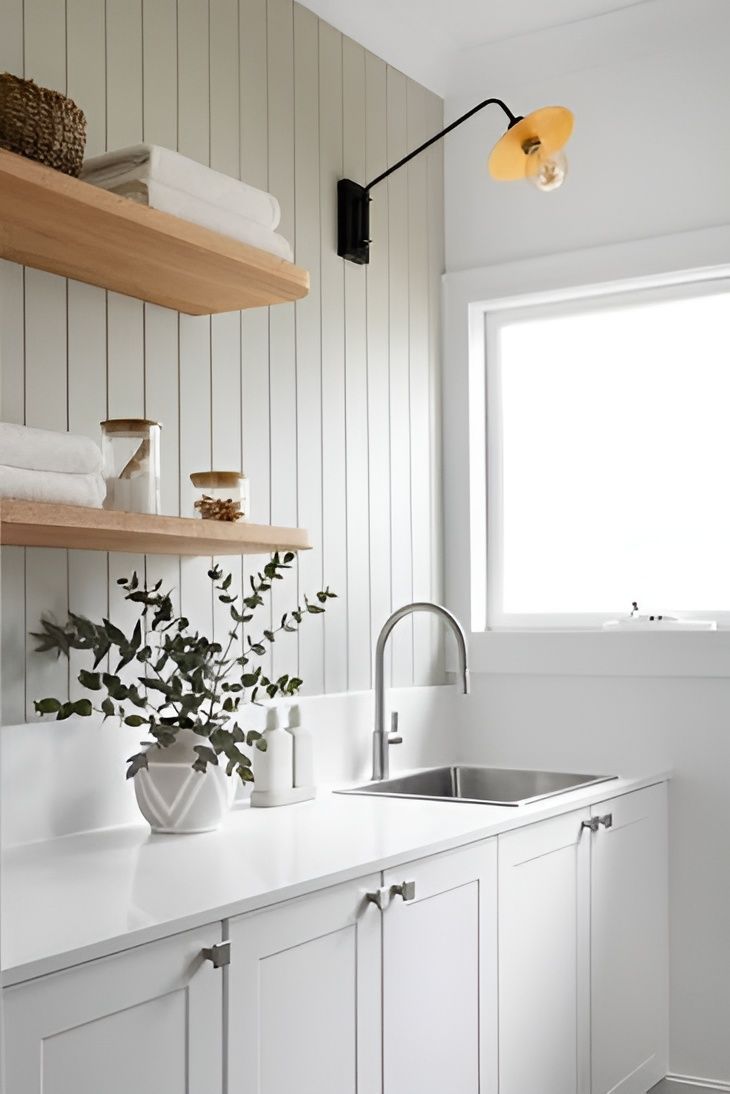 Bright Minimalist Laundry Room with White Cabinets and Open Wooden Shelves — WJG Built in Wollongbar, NSW