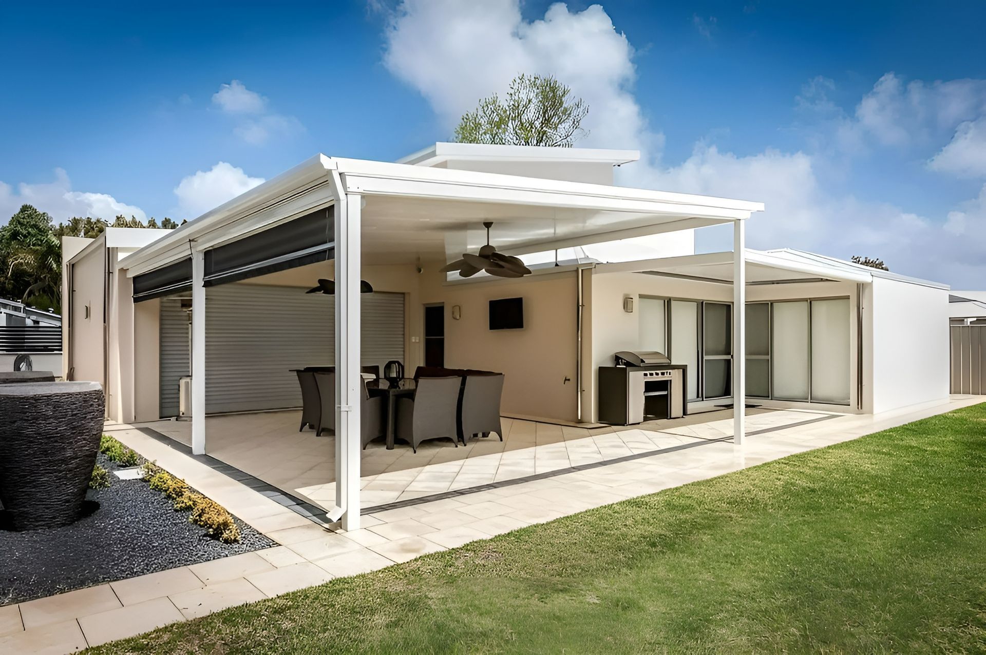 Modern White Covered Patio with Outdoor Dining and Grill Beside a Grassy Yard — WJG Built in Wollongbar, NSW