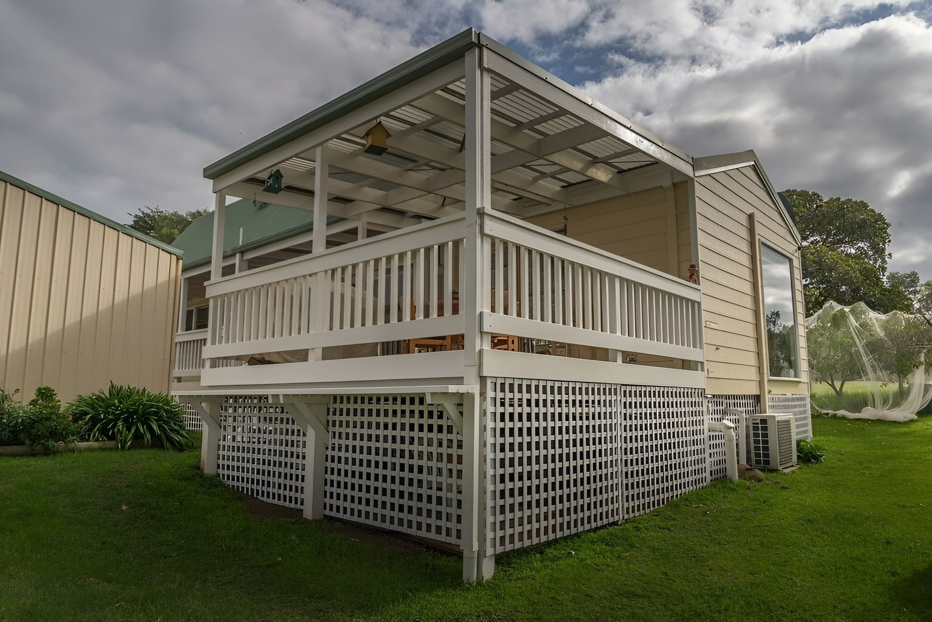 Raised Screened Porch with White Railing and Lattice Skirting on A Grassy Yard — WJG Built in Lismore, NSW