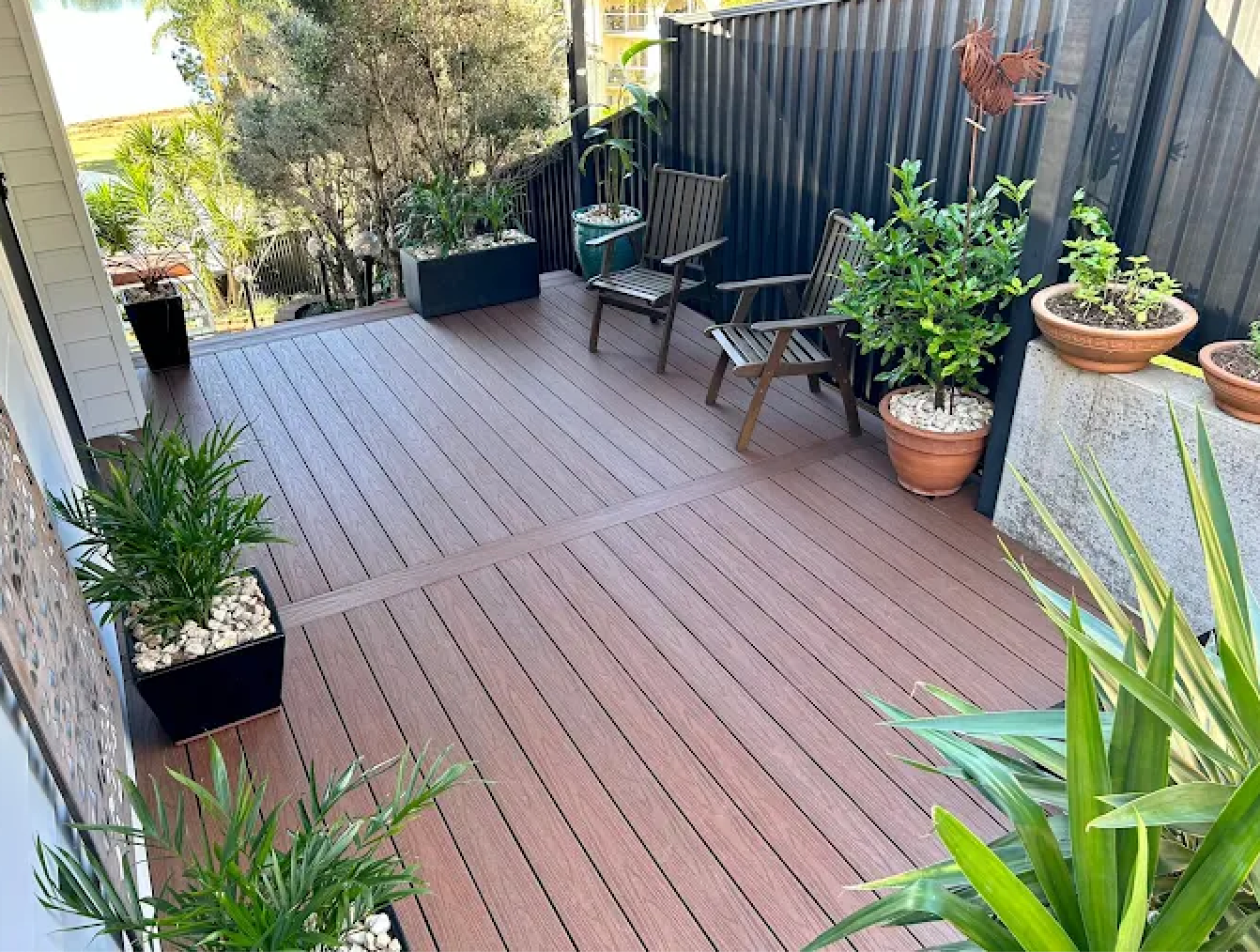 Wooden Backyard Deck with Chairs and A Black Fence Along the Side — WJG Built in Wollongbar, NSW