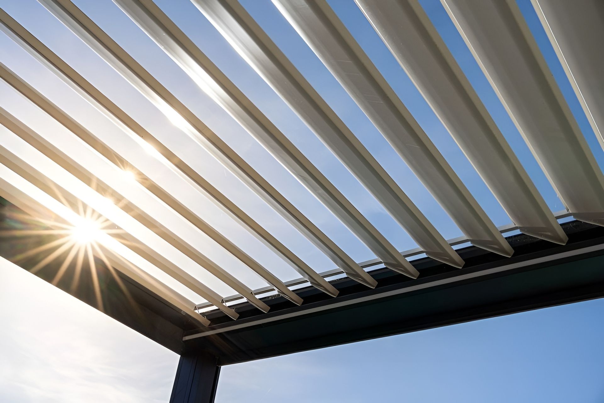 Sunlight Shining Through White Pergola Slats Against a Blue Sky — WJG Built in Wollongbar, NSW