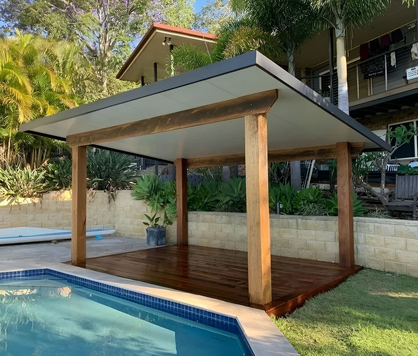 Poolside Wooden Pavilion with A Sloped Roof Beside a Swimming Pool in A Tropical Setting — WJG Built in Wollongbar, NSW