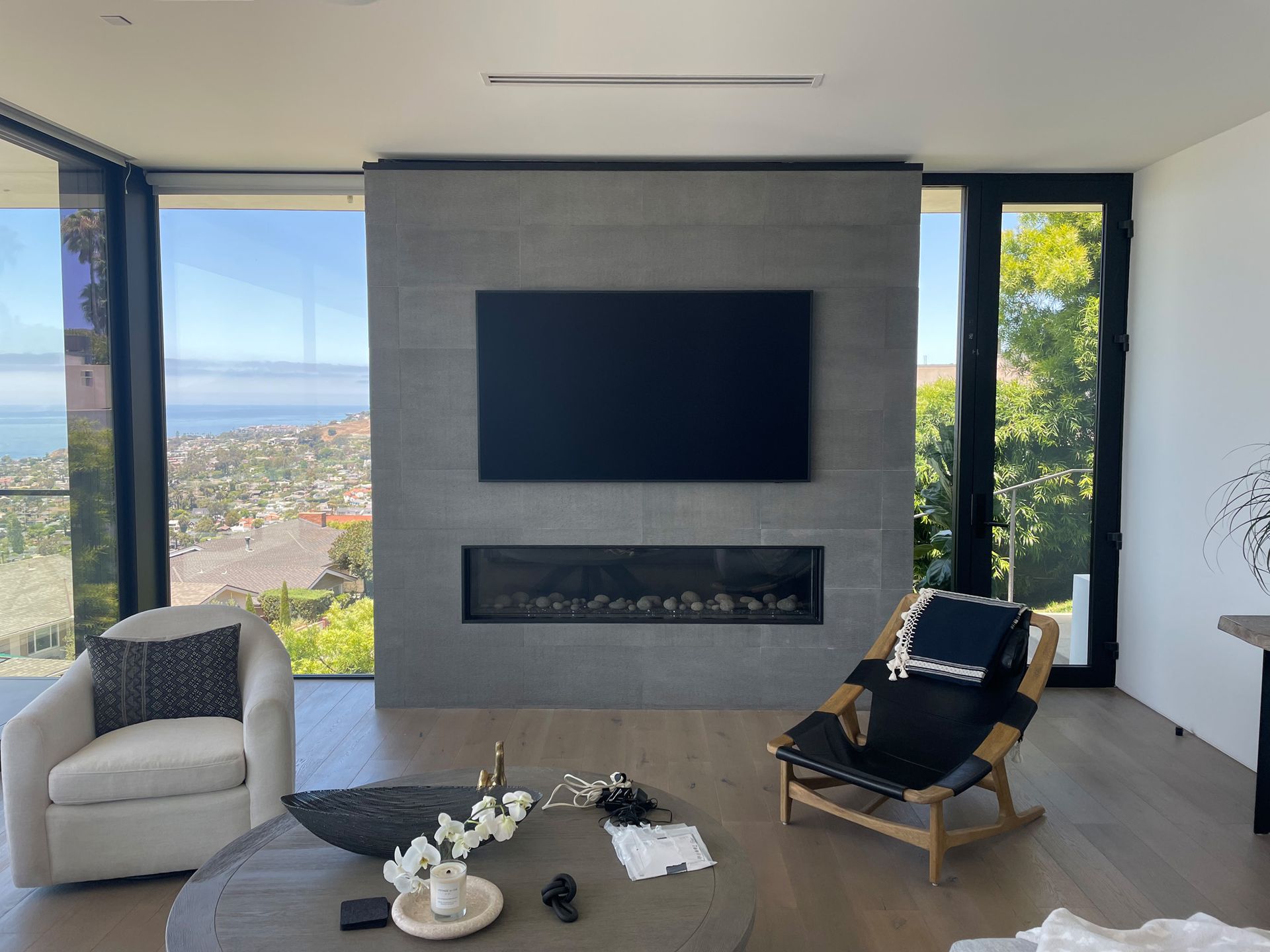 A living room with a fireplace and a flat screen tv on the wall.