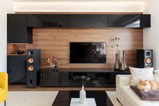 A living room with a flat screen tv and speakers