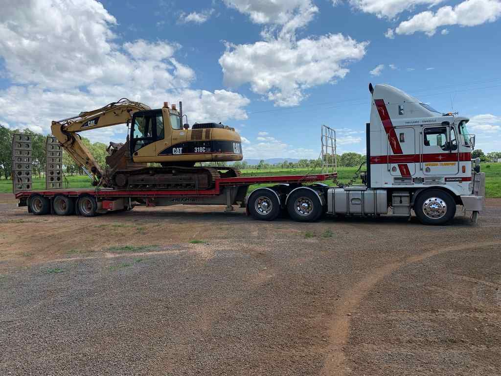 A Large Truck Carrying a Large Piece of Equipment — Taking Care of Freight in Mareeba, QLD