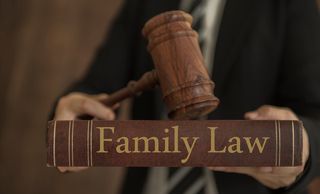 Lawyer Holding Gavel And Family Law Book — Chelmsford, MA — The Law Offices Of Kevin J. Murphy
