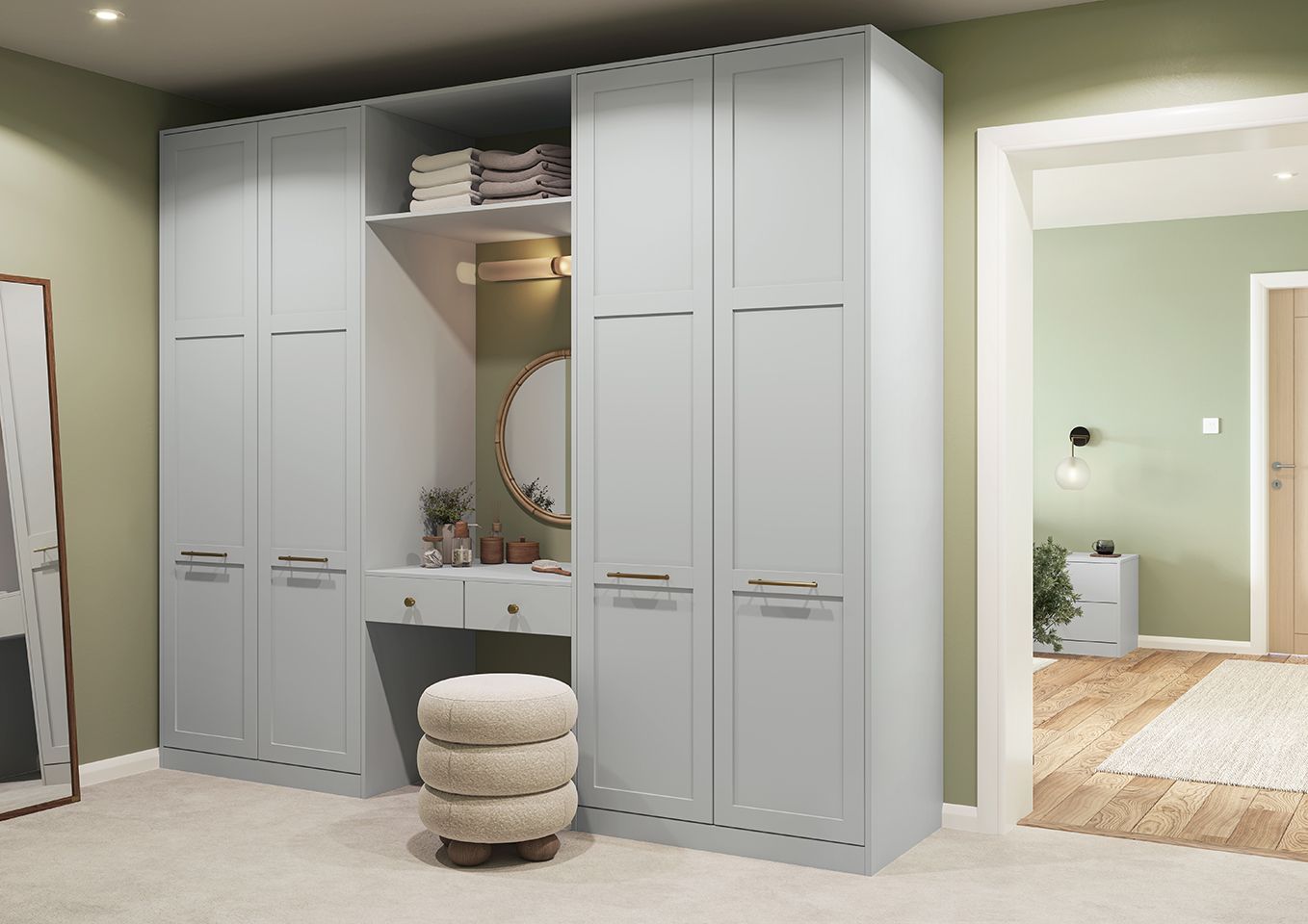 A bedroom with a large wardrobe and a dressing table