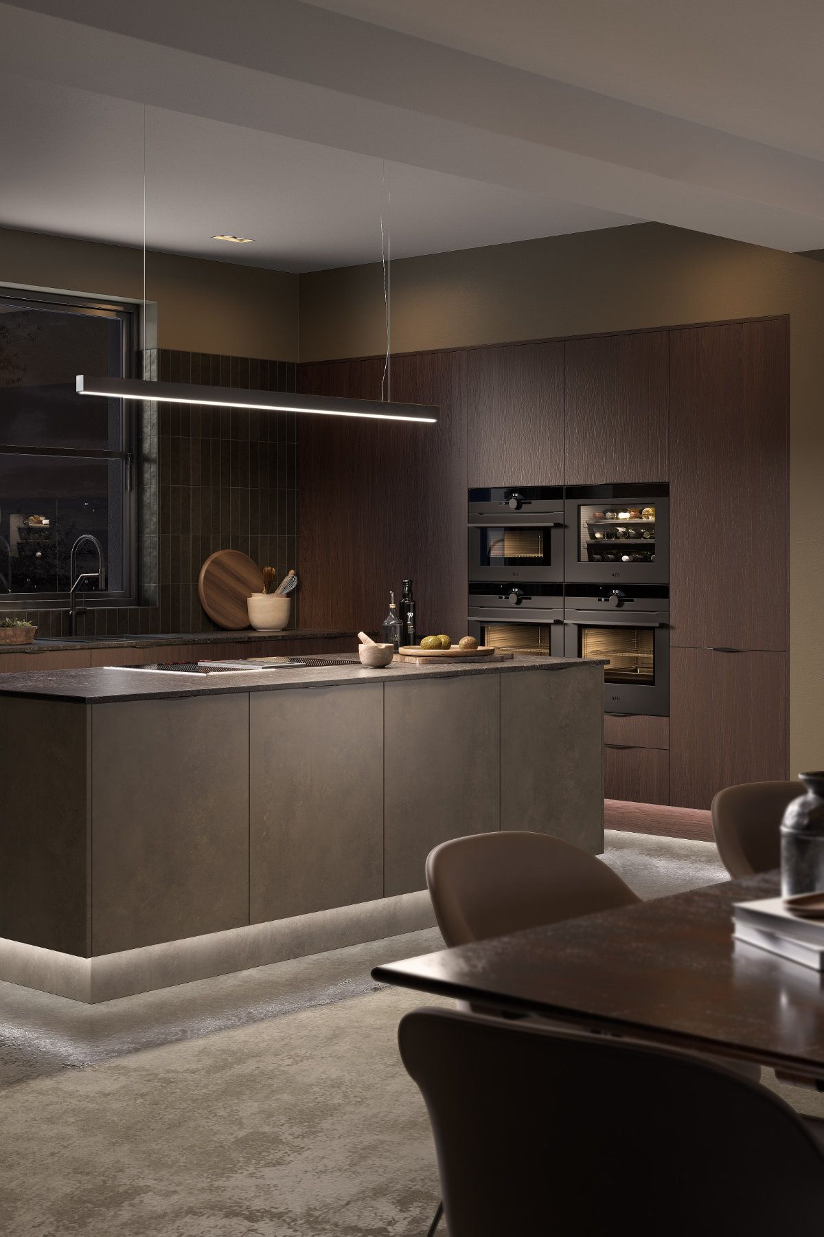 A kitchen with a large island and a table and chairs