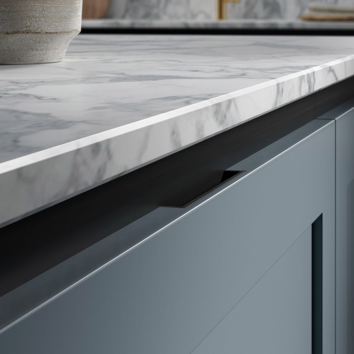 A kitchen counter with a marble counter top and blue cabinets.