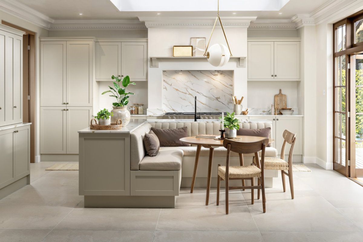 A kitchen with a couch , table and chairs in it.