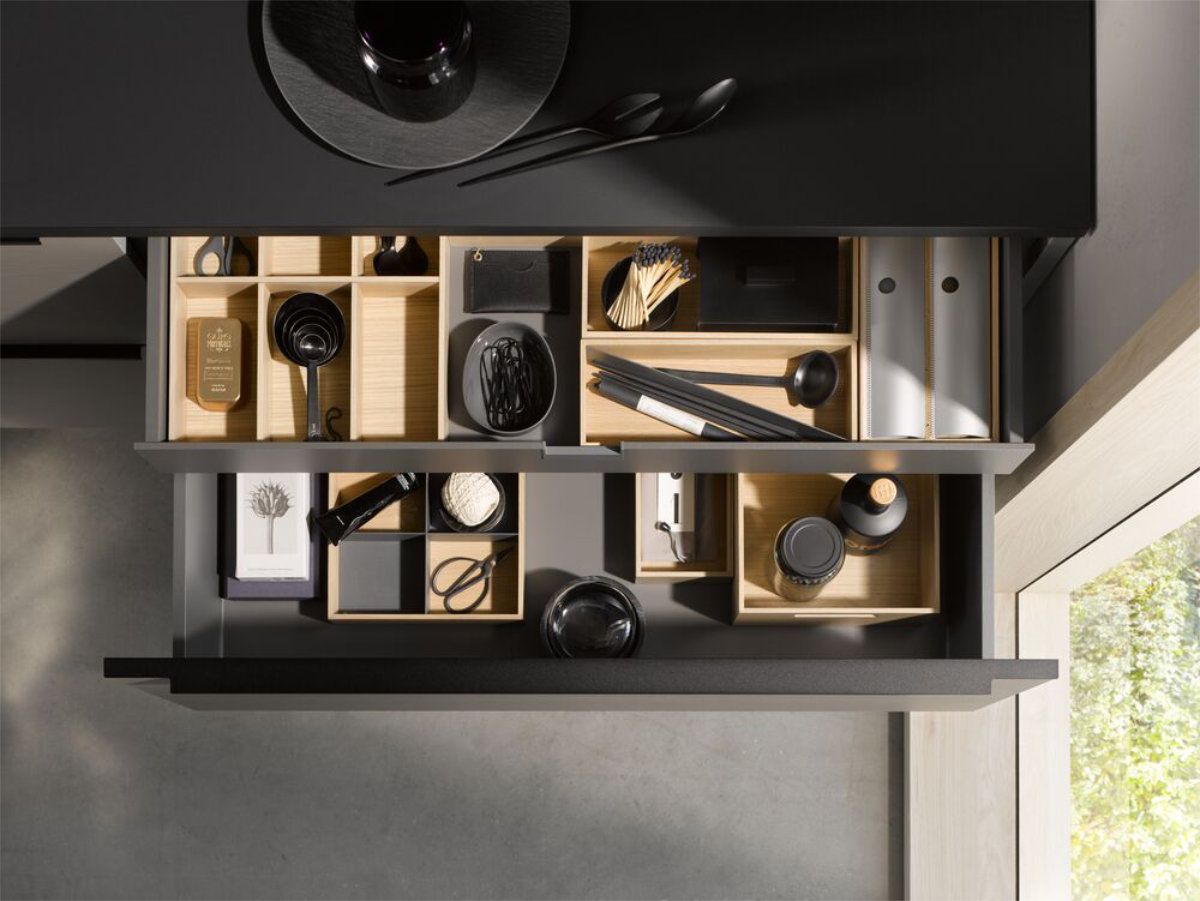 A drawer filled with a variety of items on a table.