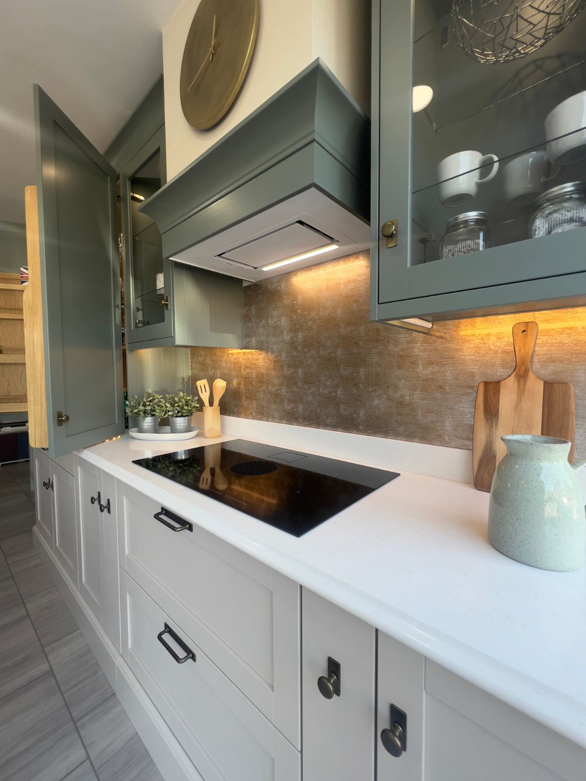 A kitchen with white cabinets and a stove top oven