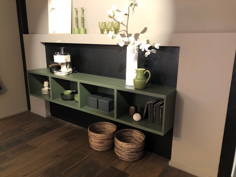 A shelf with a vase of flowers on top of it