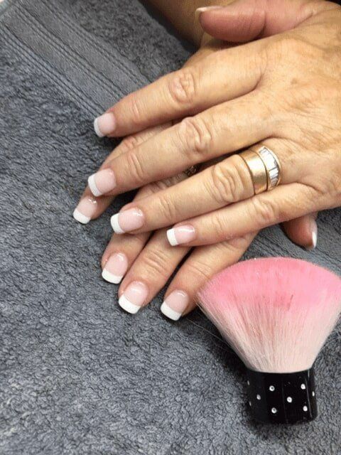 A Woman's Hands With French Manicure and a Pink Brush — Nailz By Dezign In Airlie Beach, QLD