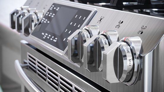 A close up of a stainless steel stove top oven.