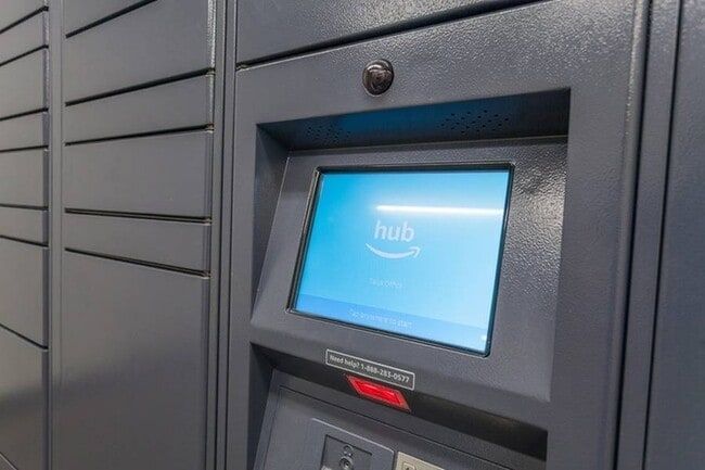 Amazon Hub locker with touchscreen display, gray metal exterior.