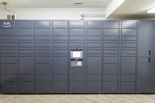 Gray Amazon Hub delivery locker system in a room.
