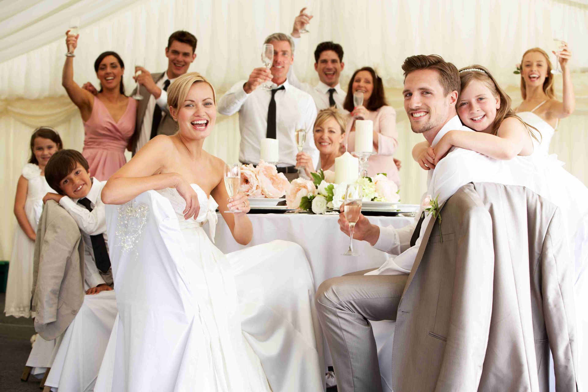 the bride and groom are toasting with their wedding party