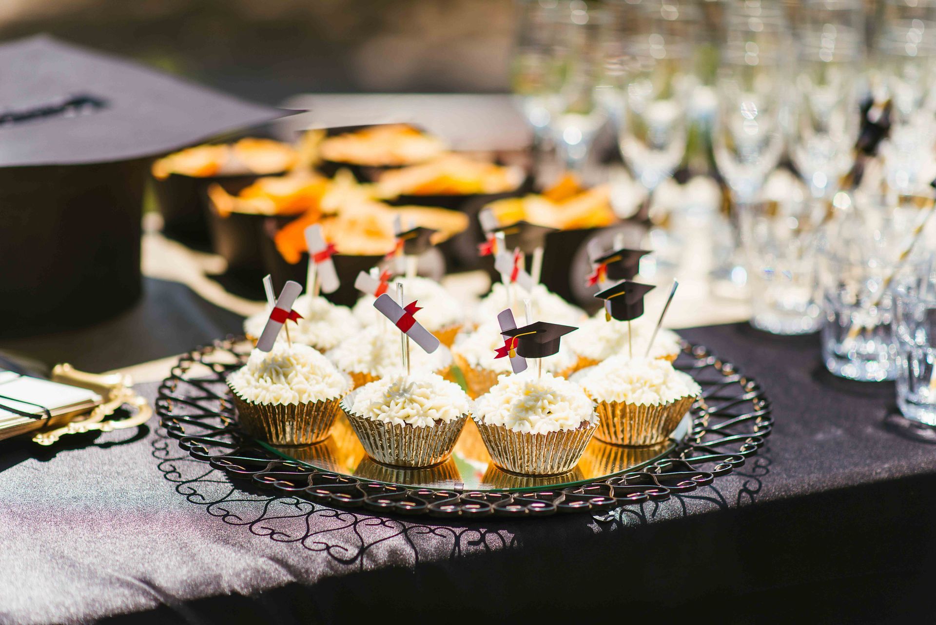 a tray of cupcakes with graduation caps on them