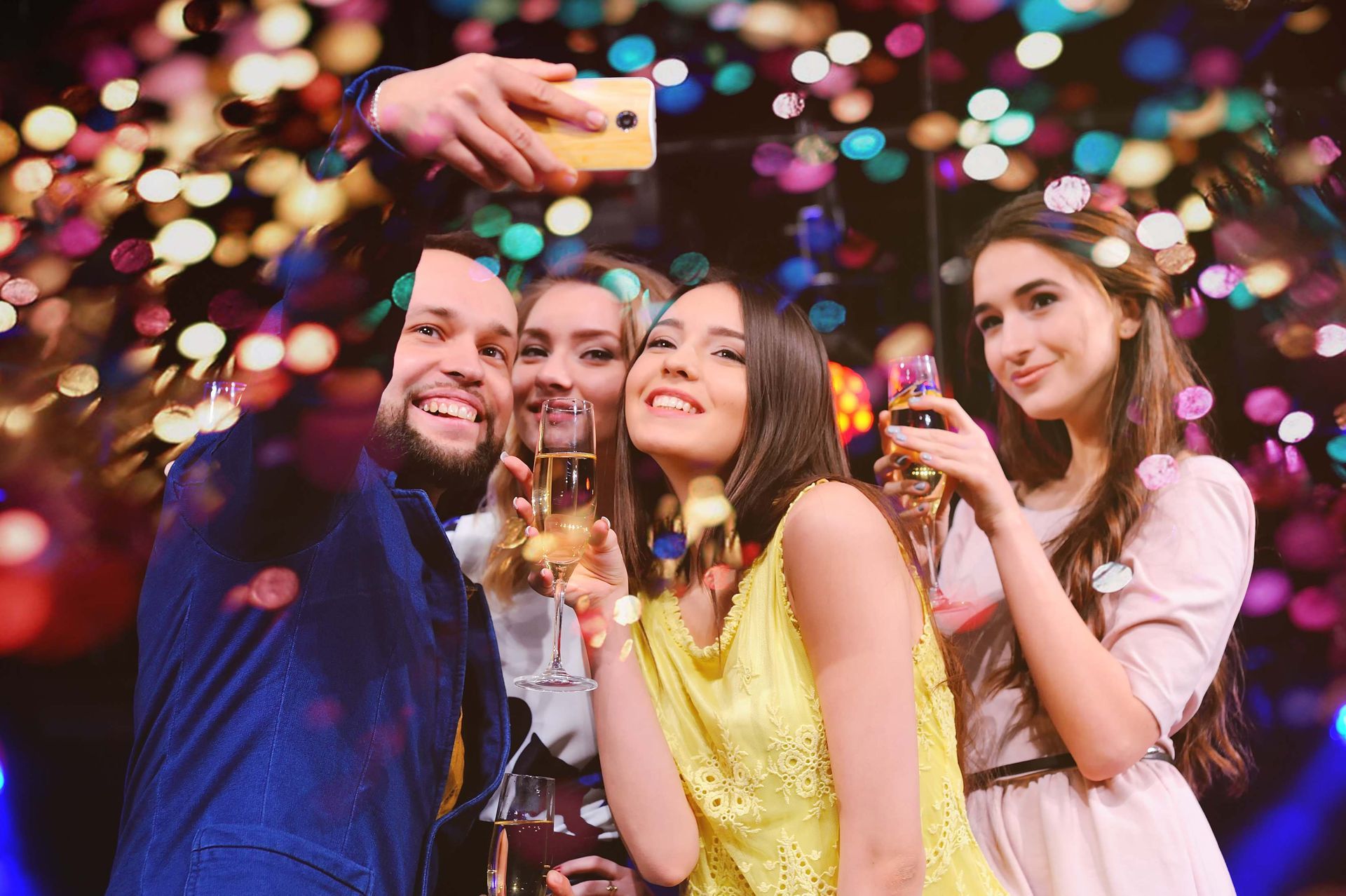 a group of people are taking a selfie at a party