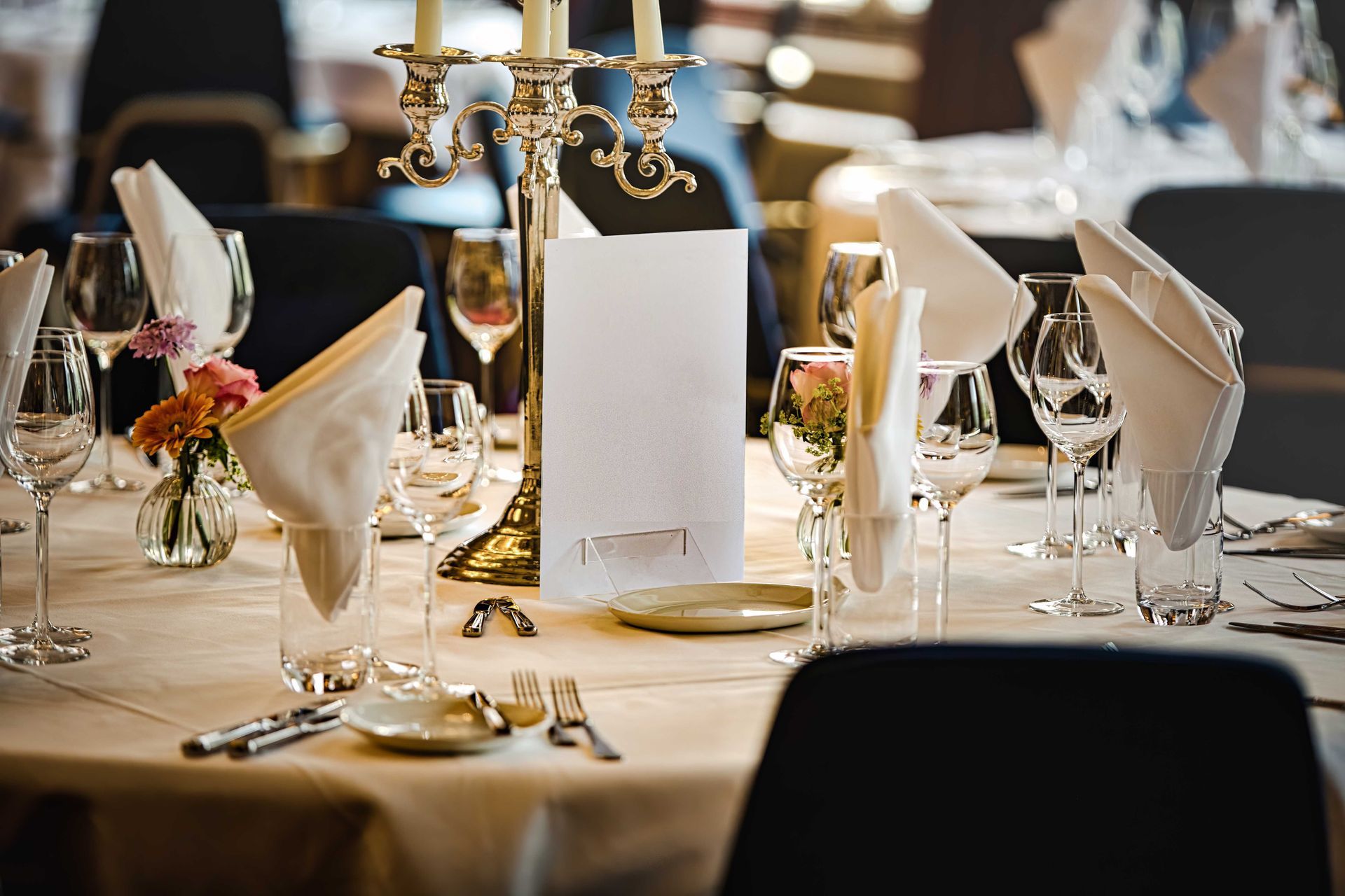 a table set for a wedding reception with a menu on it