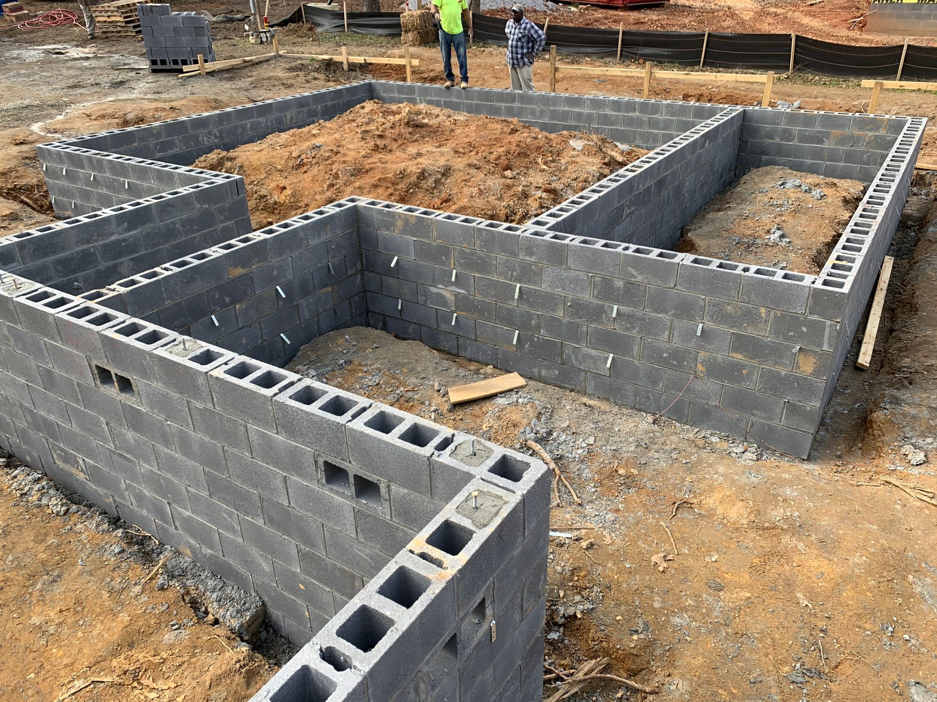 A foundation of a house is being built with concrete blocks.