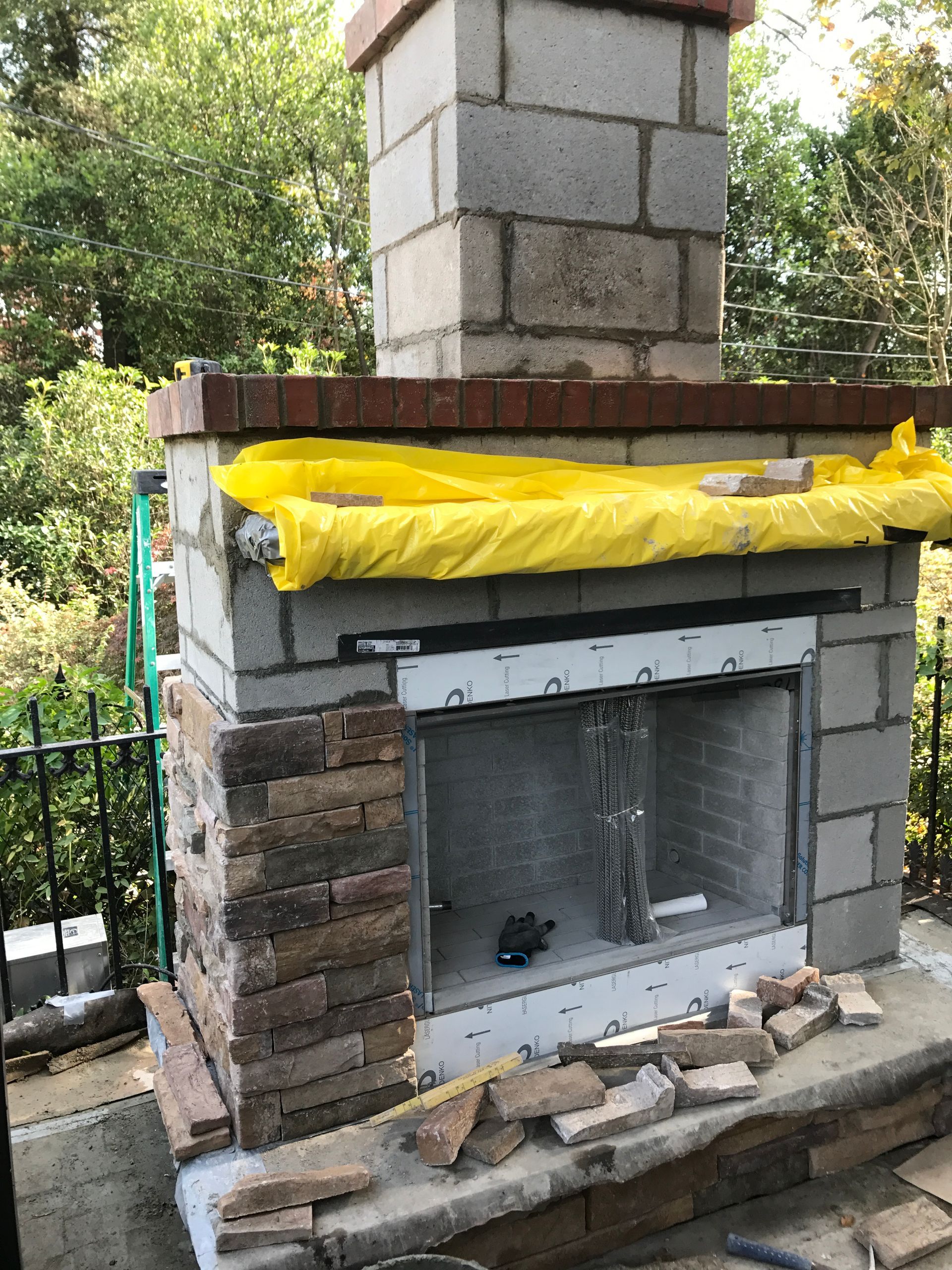 A fireplace is being built with bricks and a chimney.