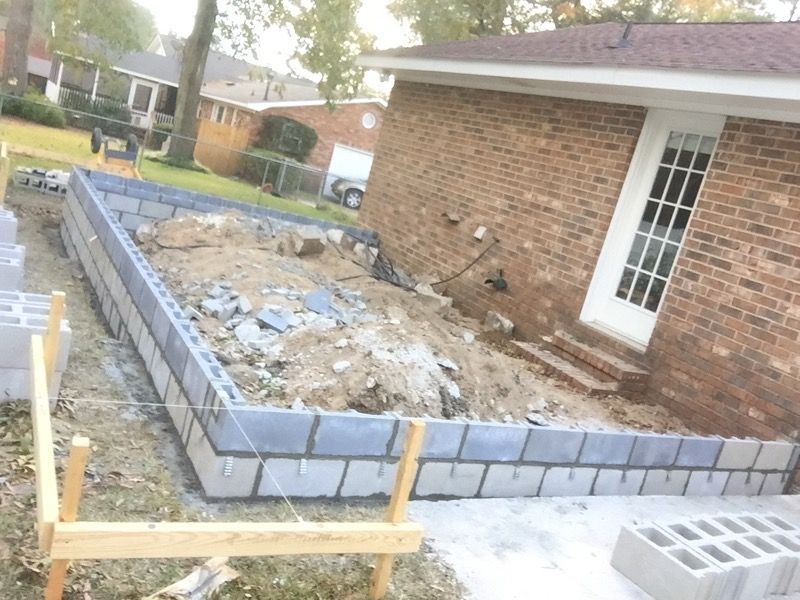 A brick house is being built with concrete blocks