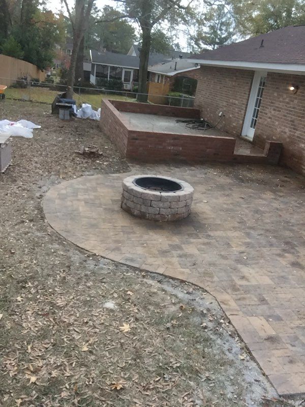 A fire pit in the backyard of a house