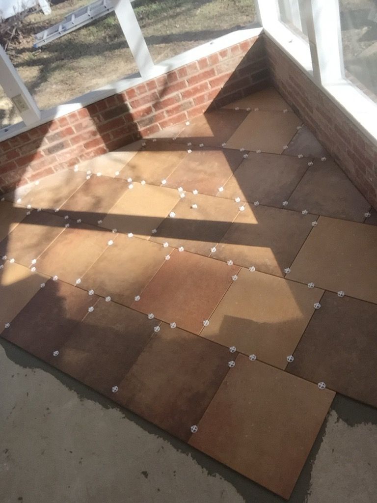 A room with a brick wall and tiles on the floor