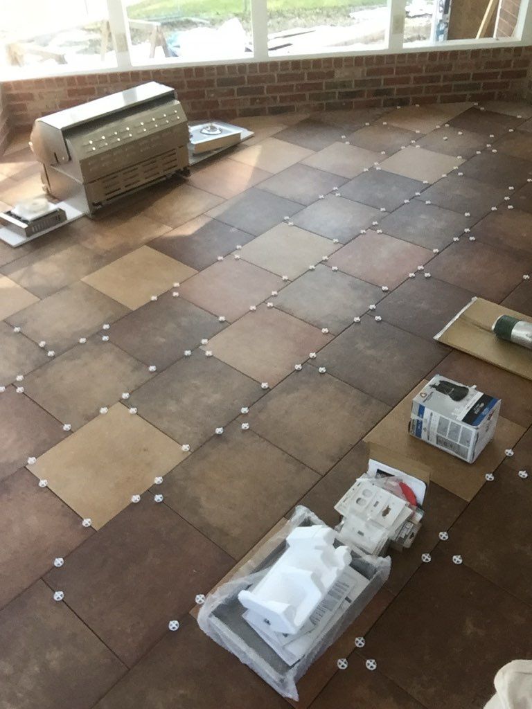 A room with a tiled floor and a brick wall.