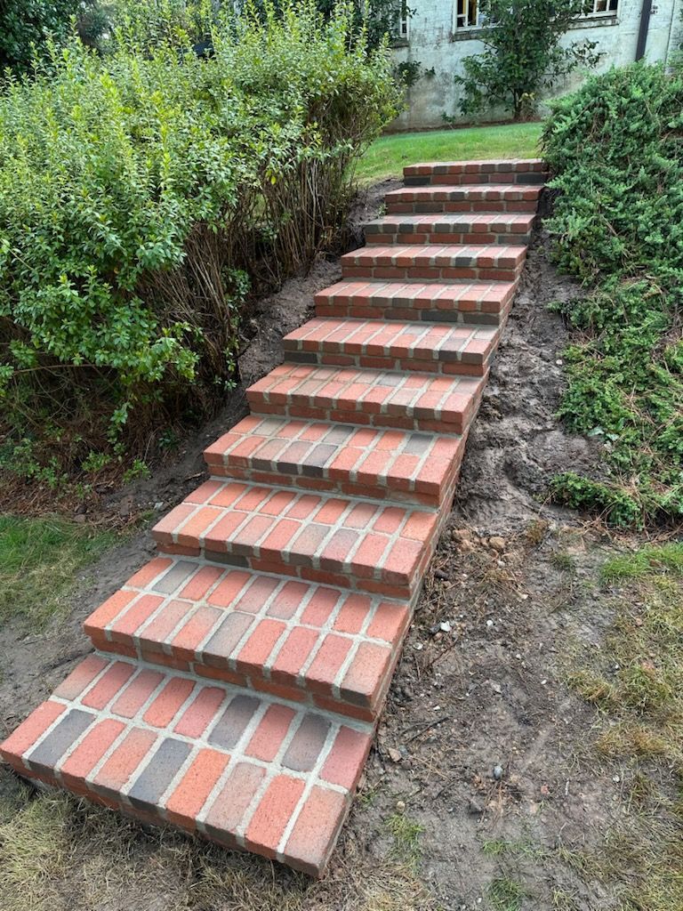A set of brick stairs leading up to a house.