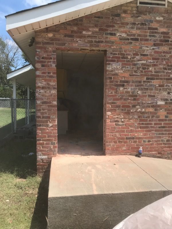A brick building with a concrete ramp leading to it