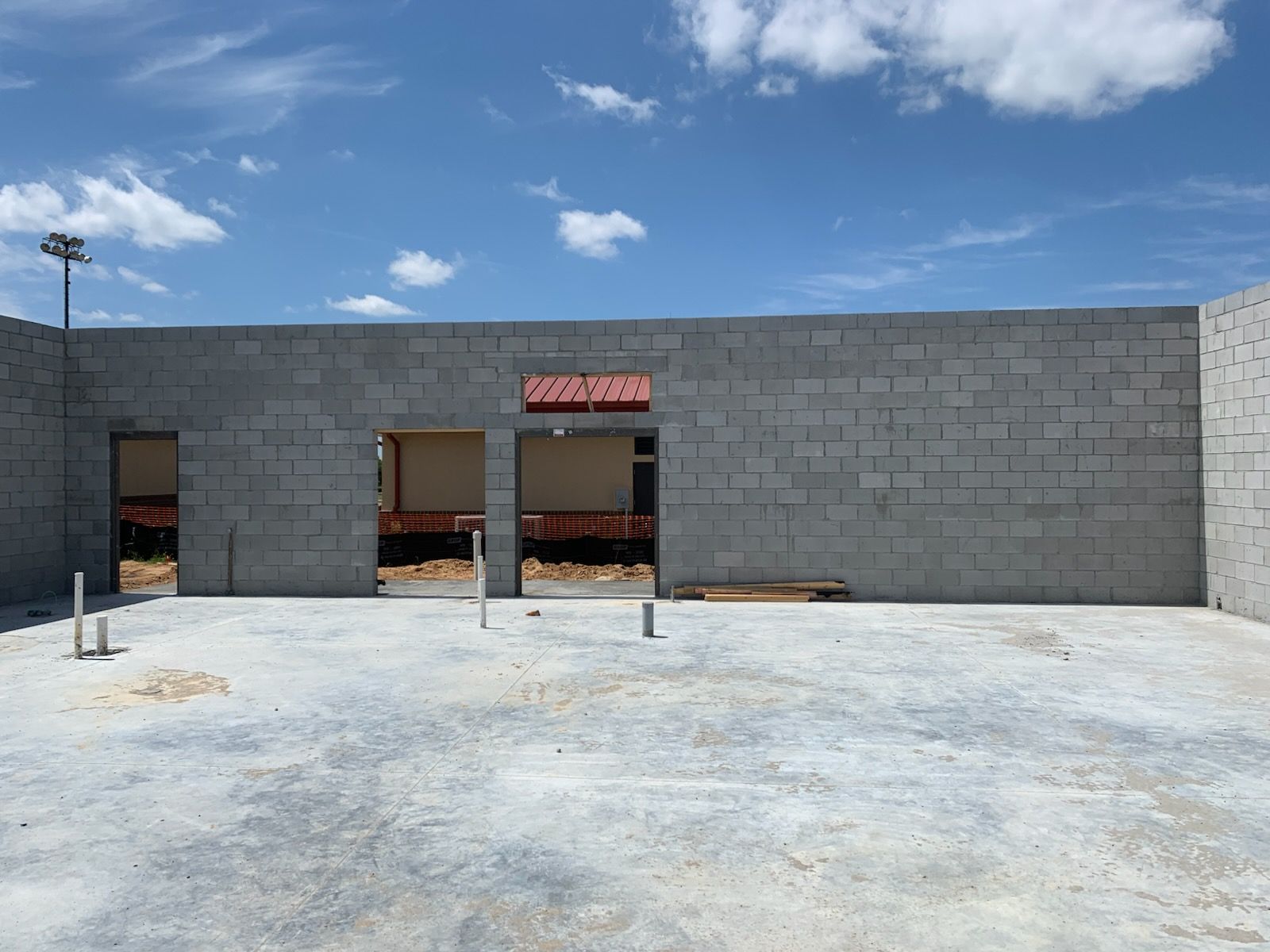 A brick building under construction with a sign that says coca cola