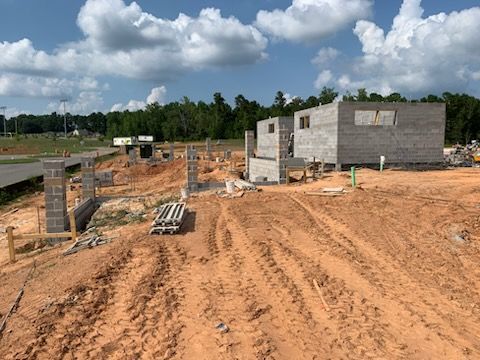 A construction site with a lot of dirt and bricks.