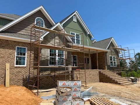A large house is being built with scaffolding around it.