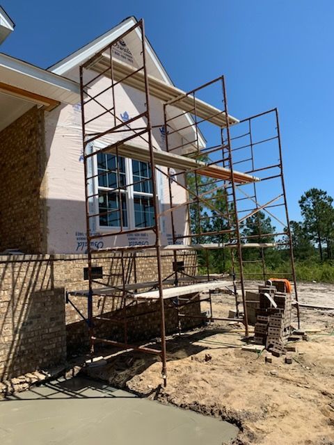A house under construction with scaffolding on the side of it